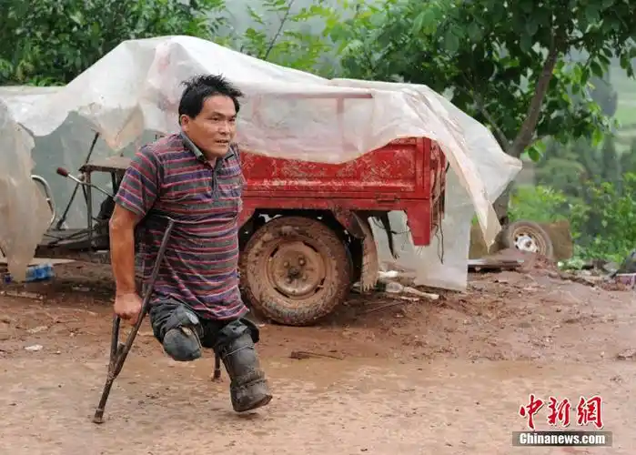 李杰文准备驾驶改造的残疾人三轮车给邻居送物资.刘忠俊 摄